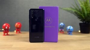 Motorola One Action on the Wooden table with Retail Box