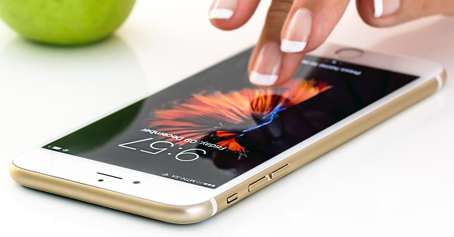 iPhone on the White Table With Green Apple Fruit