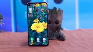 Samsung Galaxy A8s with Baby Groot Toy Background