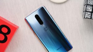 OnePlus 8 on the Wooden table with D Brand Qube