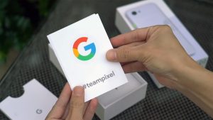 Google Pixel 3a Mobile in the background with team pixel sticker
