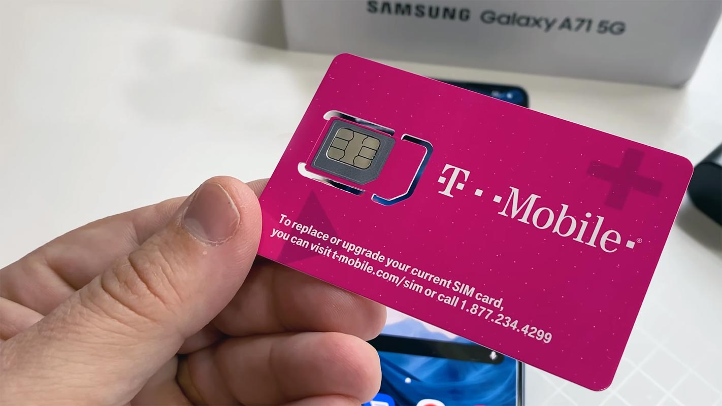 T-Mobile SIM card in Hand with Samsung A71 5G in Background