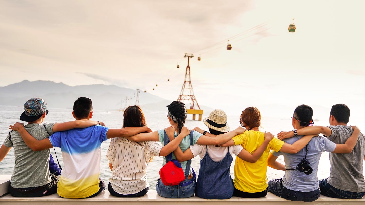 Friends Put hand on Shoulders and Watching Sea