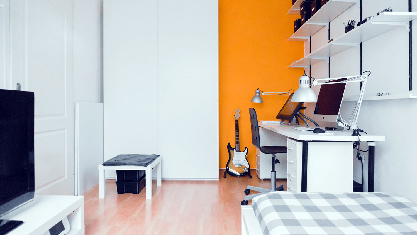 Dorm Room with Laptop and Bed